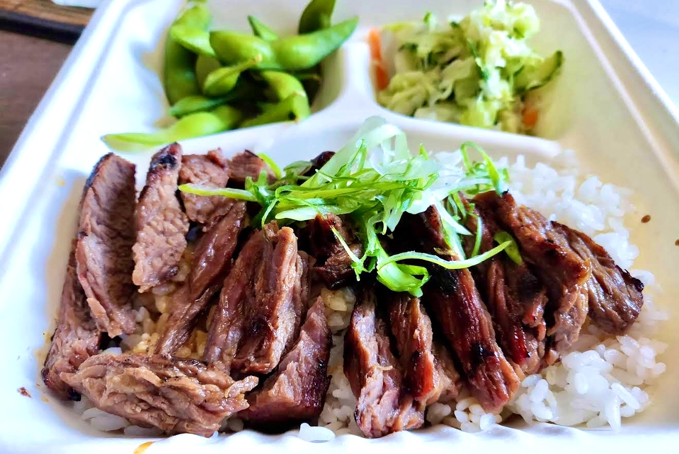 Marinated Angus beef teriyaki over steamed rice with edamame and salad